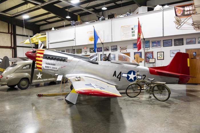 Historic flight gear and pilot helmets on display