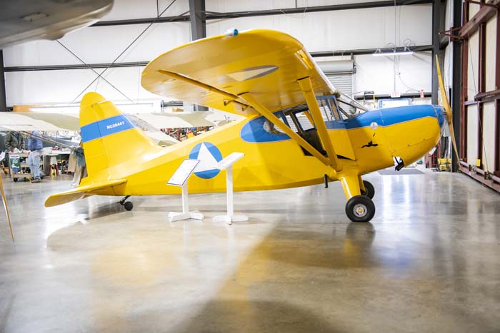 Vintage aircraft restoration in progress inside hangar