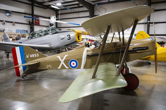 Rows of aviation books and WWII documentaries in museum library