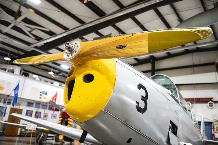 Docent explaining aircraft restoration process to visitors