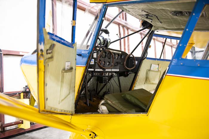 Restored military truck parked inside museum hangar